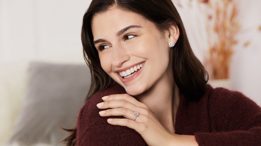 Caucasian woman smiling wearing engagement ring